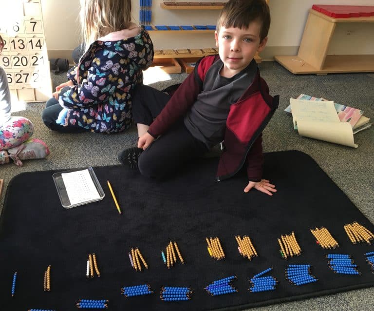 montessori student solving mathematical problems in children's house