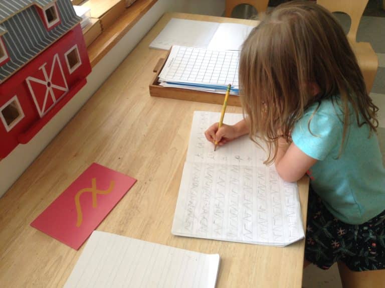 montessori school helping kids with their writing