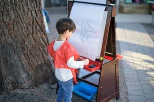 montessori child showcasing his art